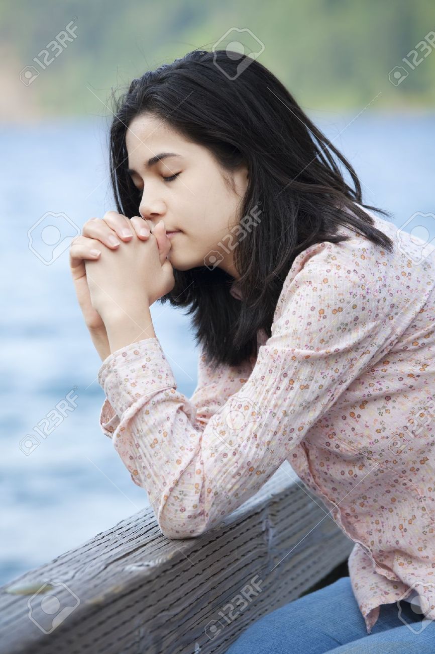 Black teen girl praying